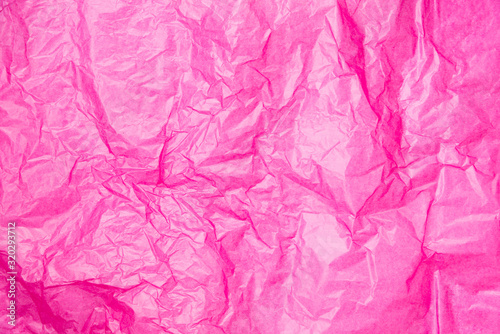Abstract background pink crumpled transparent paper on white paper.