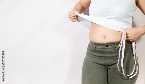 Woman diet lifestyle concept to reduce belly and shape up healthy stomach muscle.