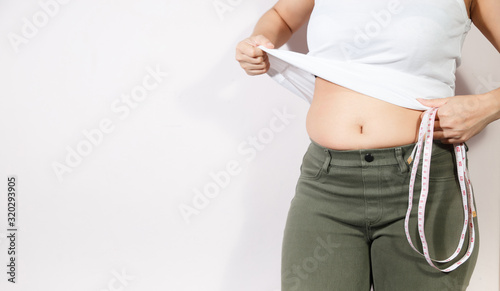 Photography Woman diet lifestyle concept to reduce belly and shape up healthy stomach muscle