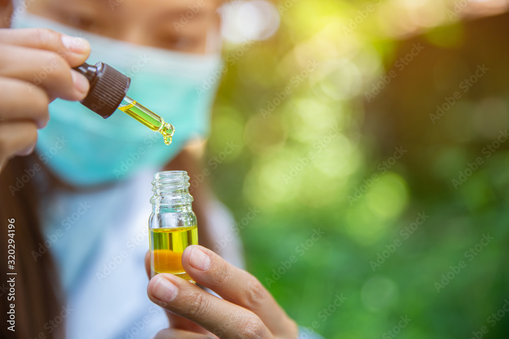 The hands of scientists dropping marijuana oil for experimentation and research, ecological hemp plant herbal pharmaceutical cbd oil from a jar. The hands of scientists dropping marijuana oil for experimentation and research, ecological hemp plant herbal pharmaceutical cbd oil from a jar.