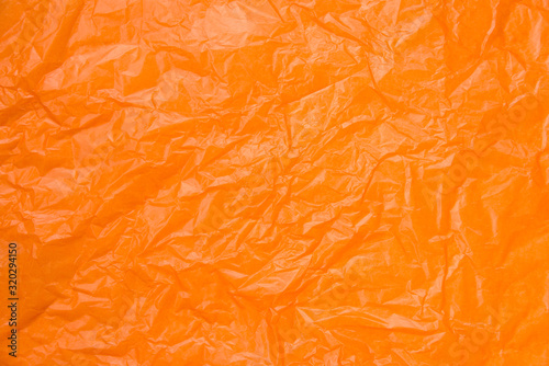 Close up wrinkled orange paper is beautiful. selective focus with blurred foreground and background.