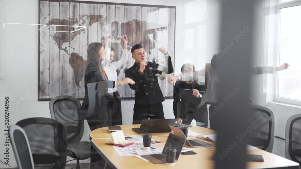 businessmen dancing in the office by the glass businessmen dancing in the office by the glass