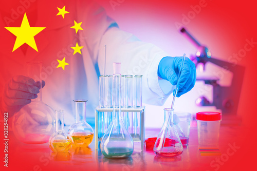 Development of chemistry in China. Chemical industry of China. Chemical research in the laboratory on the background of the flag of the Republic of China. Use of new experimental data in industry.