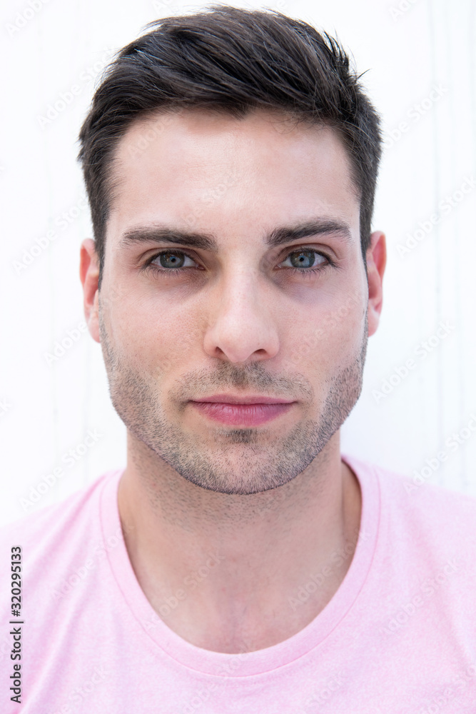Close up handsome young man by white background Close up handsome young man by white background