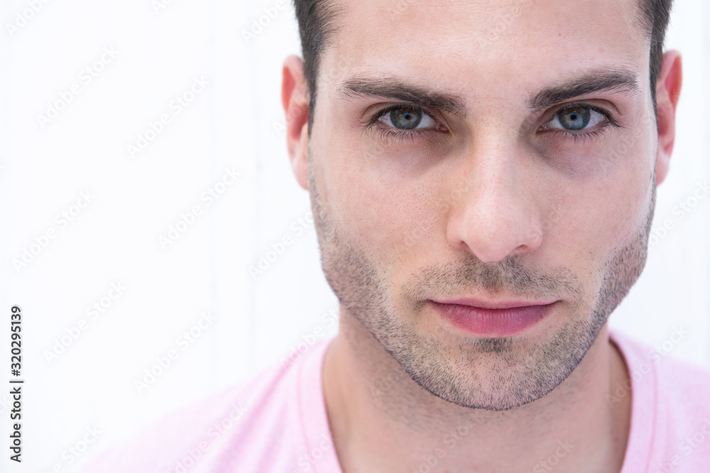 Horizontal portrait of handsome young man staring by white background Horizontal portrait of handsome young man staring by white background