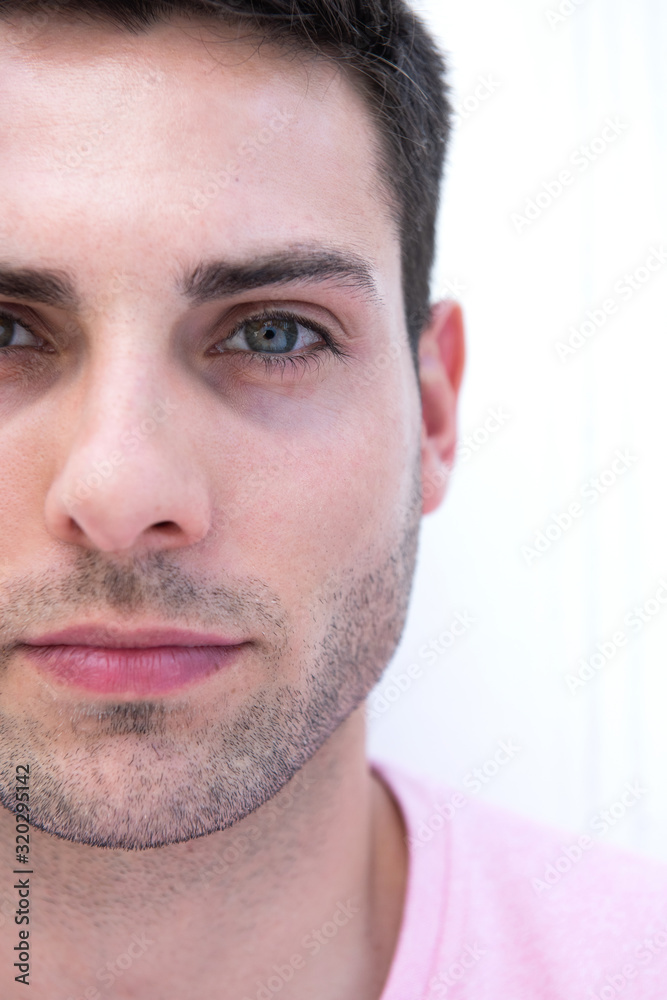 Cropped face portrait of male fashion model by white background Cropped face portrait of male fashion model by white background
