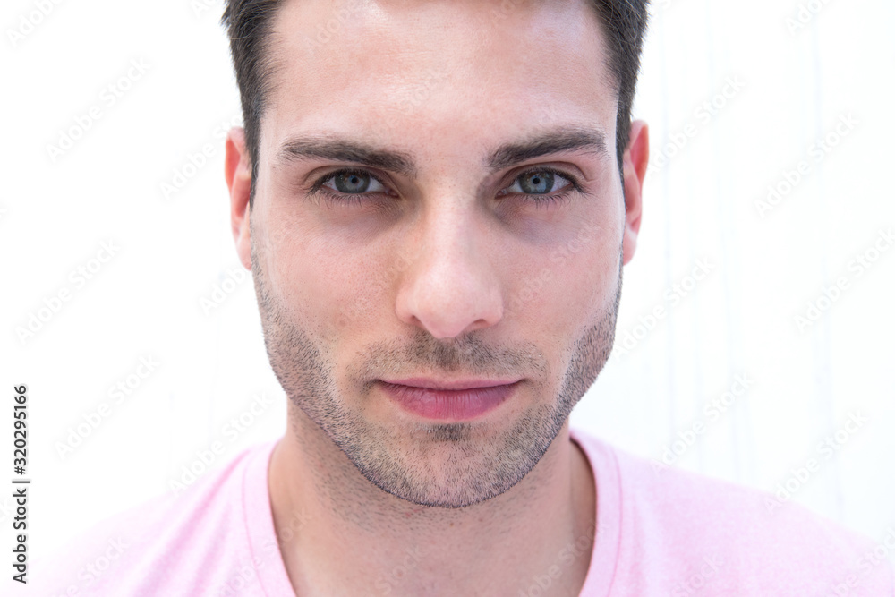 Front portrait of handsome young man staring by white background Front portrait of handsome young man staring by white background