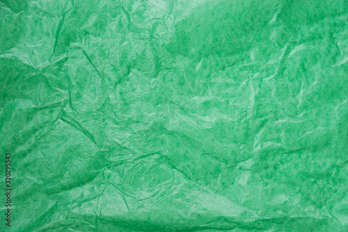 abstract background green crumpled transparent paper on white paper.