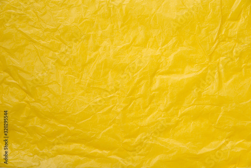 abstract background yellow crumpled transparent paper on white paper.