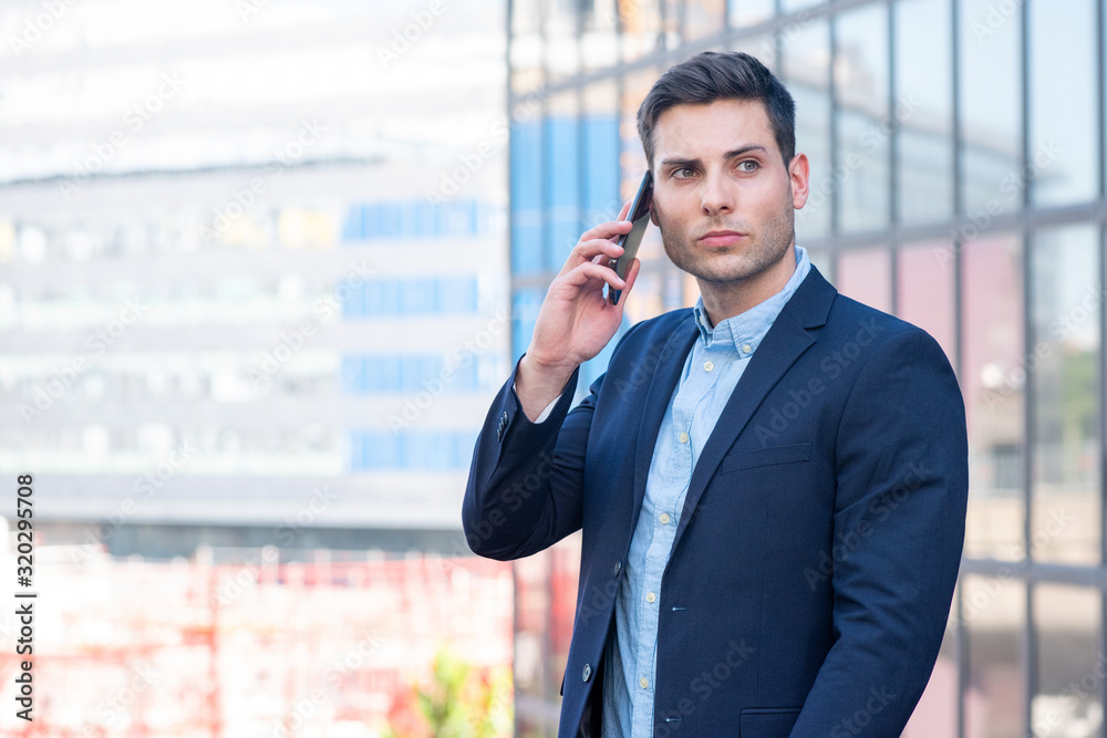 Side of businessman talking with mobile phone in city Side of businessman talking with mobile phone in city