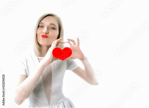 Valentine's day. Girl in a white dress on a white background with a heart.