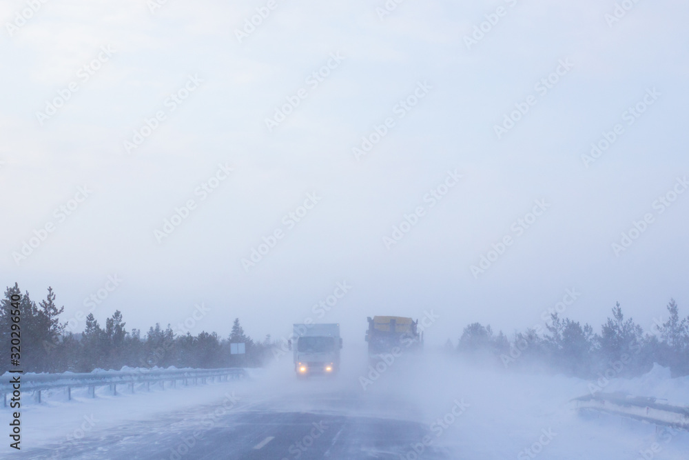 cars go on a winter road with poor visibility, weather and snowstorm cars go on a winter road with poor visibility, weather and snowstorm
