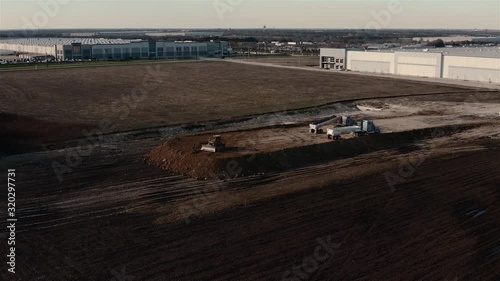 A Catepillar tractor loader pushes the dirt while building a solid foundation. photo