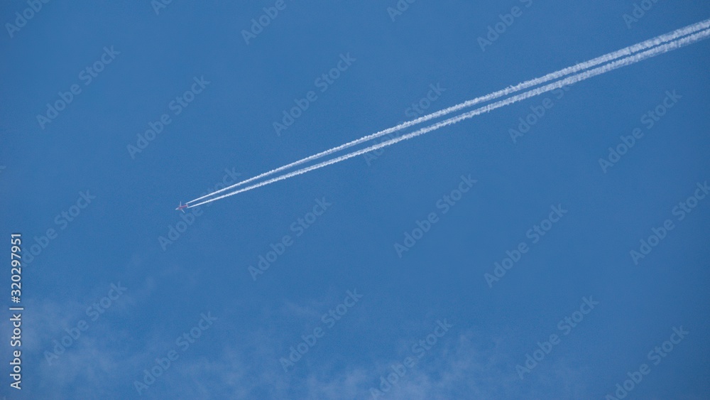 Aircraft flying through the sky blue, Condensing traces in the background. Aircraft flying through the sky blue, Condensing traces in the background.
