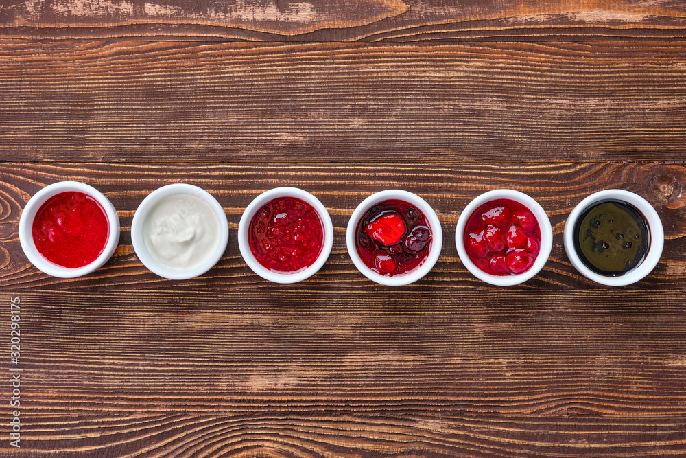 Overhead view of assortment of fruit puree. Jam, confiture, chutney or sauce from berries. Overhead view of assortment of fruit puree. Jam, confiture, chutney or sauce from berries.