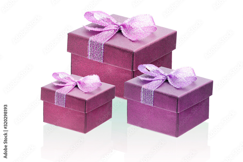 Obraz premium Three cherry color gift boxes isolate on a white background, close-up, reflection