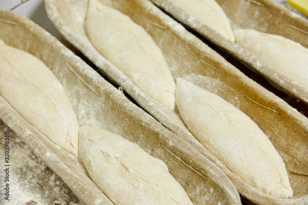 Fototapeta premium pieces of dough in a row in a bowl, pastries, flour products