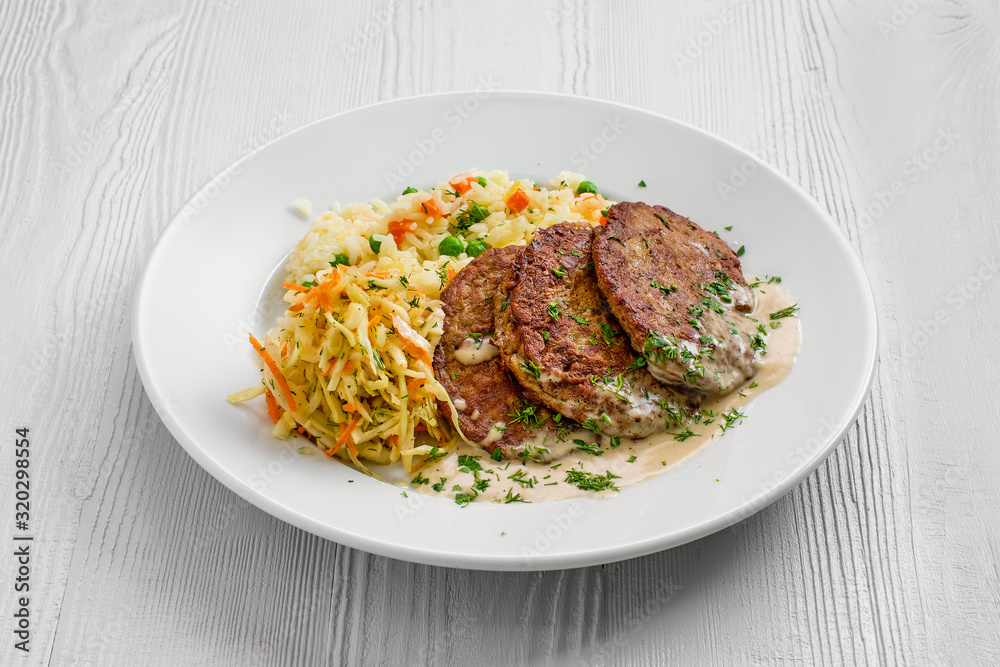 Plate with liver cutlet, rice with peas and pickled cabbage Plate with liver cutlet, rice with peas and pickled cabbage