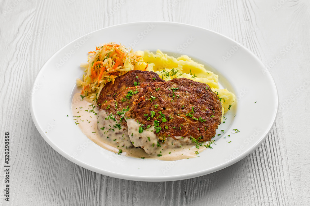 Plate with liver cutlet,mashed potato and pickled cabbage Plate with liver cutlet,mashed potato and pickled cabbage