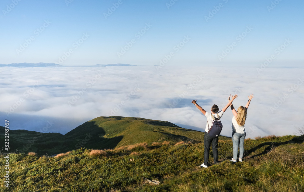 Cheering celebrating happy people at hike excited with arms raised up at sunset. Cheering celebrating happy people at hike excited with arms raised up at sunset.