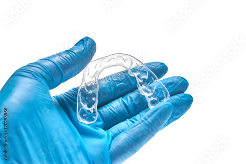 Hand holding individual dental tray for bleaching teeth Isolated on a white background photo