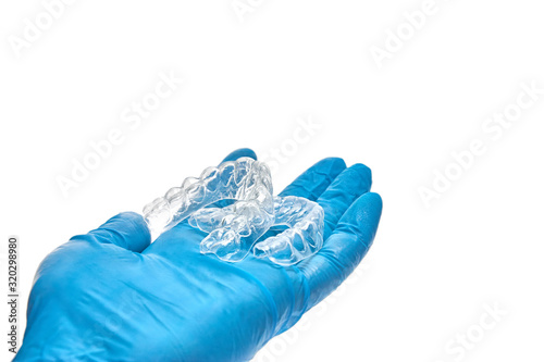 Wallpaper Mural Hand is holding set of custom dental trays for bleaching teeth. Isolated on a white background Torontodigital.ca