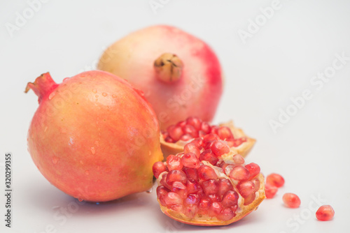 The still life photos of beautiful pomegranate fruit and pulp on a white background.