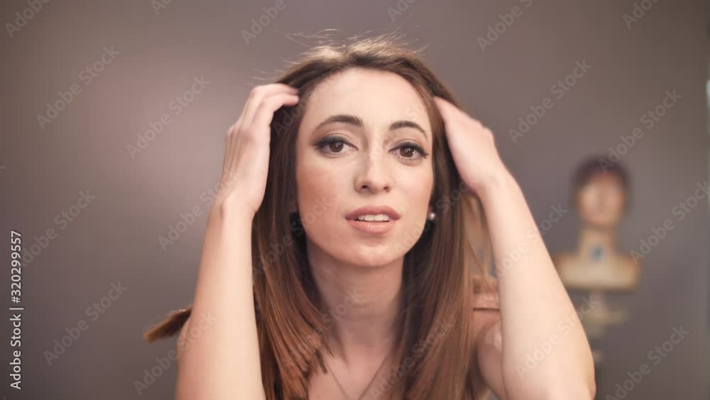 Portrait of beautiful woman playing with her hair blowing kiss and walks away Portrait of beautiful woman playing with her hair blowing kiss and walks away