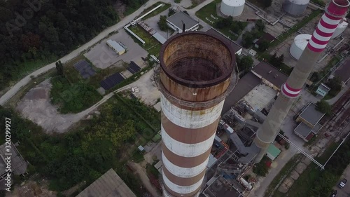 Circling drone shot around factory chimneys photo