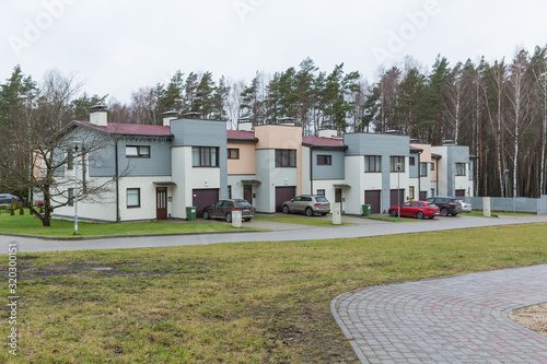 City Bergi, Latvia. Living house and street. Cars and garden. © ynos
