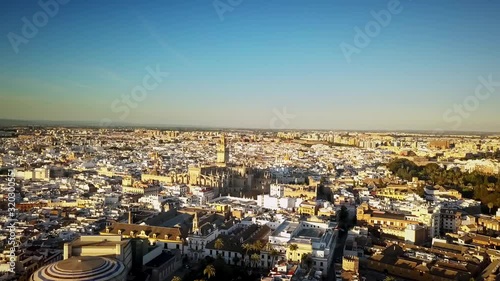 Drone shot moving toward Seville, Spain's La Giralda Tower at sunset. 
4K 60fps photo