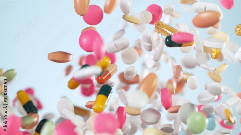Super slow motion of flying mix of coloured pills on white background. Filmed on high speed cinema camera. Super slow motion of flying mix of coloured pills on white background. Filmed on high speed cinema camera.