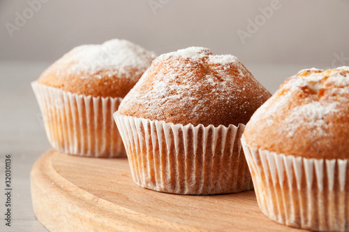 Tasty muffin closeup on a wooden board, selective focus.