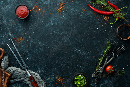 Fototapeta Naklejka Na Ścianę i Meble -  Dark cooking banner. Vegetables and spices on the kitchen table. Top view. Free space for your text.