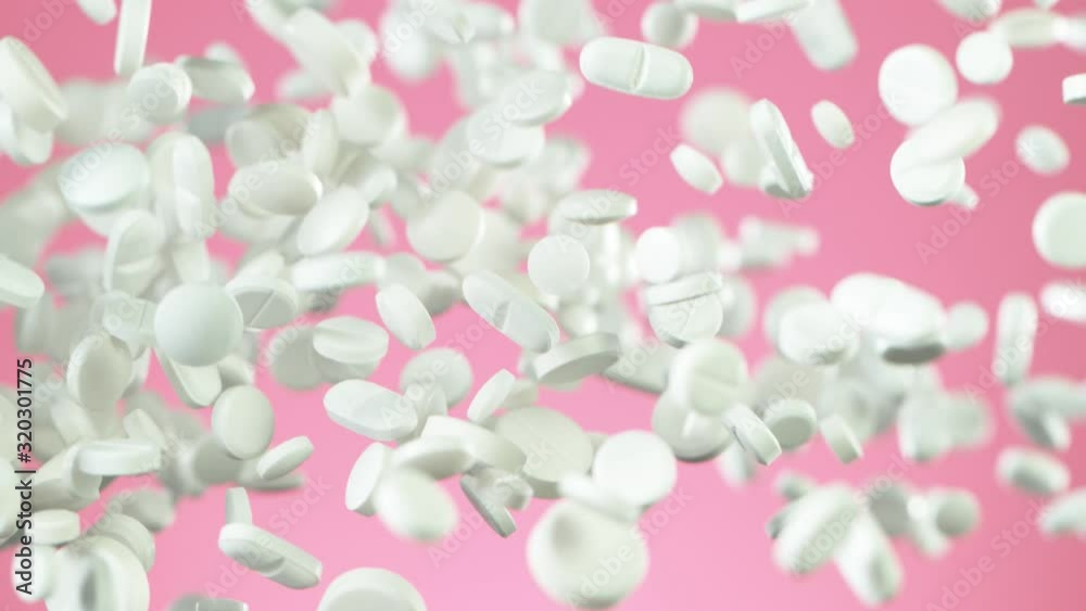 Super slow motion of falling white pills on pink background. Filmed on high speed cinema slow motion camera, 1000fps. Super slow motion of falling white pills on pink background. Filmed on high speed cinema slow motion camera, 1000fps.