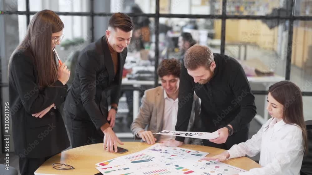 team is working on the strategy of the company in the office by the glass team is working on the strategy of the company in the office by the glass