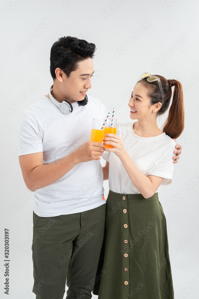 A healthy young asian couple drinking orange juice A healthy young asian couple drinking orange juice