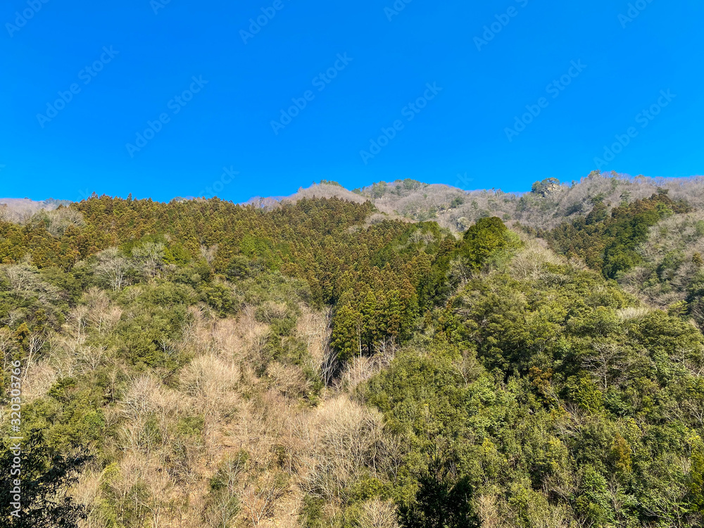 Mountains and blue sky behind mountains in Japan.