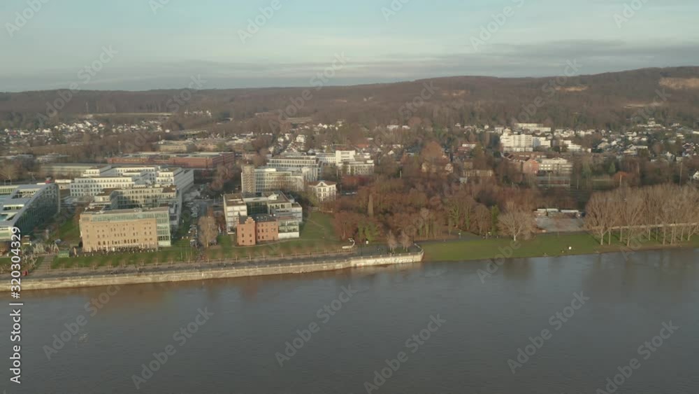 Panorama drone / aerial shot of Bonn, Königswinter, Oberkassel and the river rhine the post tower, the kameha grand hotel and the konrad adenauer bridge at the afternoon golden hour, 30p Panorama drone / aerial shot of Bonn, Königswinter, Oberkassel and the river rhine the post tower, the kameha grand hotel and the konrad adenauer bridge at the afternoon golden hour, 30p