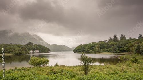 A rainy grey day at Muckross Lake, also called Middle Lake or The Torc, in Killarney National Park, County Kerry, Ireland.