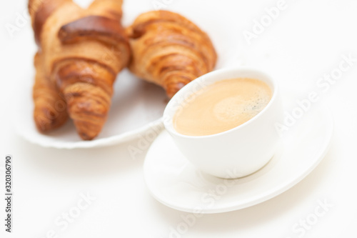 Hot aromatic coffee and French croissant. Nice, tasty breakfast in the cafe or at home.