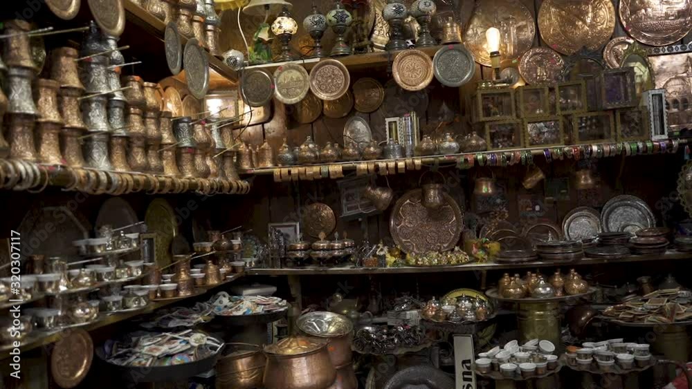Street souvenirs bazaar in Sarajevo full with delight cups, pots, tea kettles and antiques made of copper. Traditional cooper antique shop made by Coppersmith in capital city of Bosnia, Sarajevo. Street souvenirs bazaar in Sarajevo full with delight cups, pots, tea kettles and antiques made of copper. Traditional cooper antique shop made by Coppersmith in capital city of Bosnia, Sarajevo.