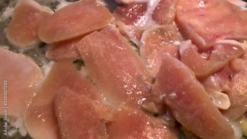 Home made cooking concept of healthy food. Raw chicken breast meat cooking in a frying pan. Home made cooking concept of healthy food. Raw chicken breast meat cooking in a frying pan.