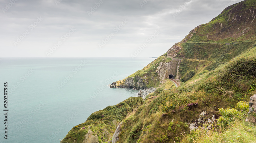 Railway line and tunnel on the cliffs near Bray, County Wicklow on the east coast of Ireland.