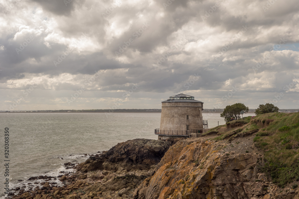 View of a Martello Tower and Dublin Bay at Red Rock, Sutton on Howth Head Peninsula near Dublin, Ireland.