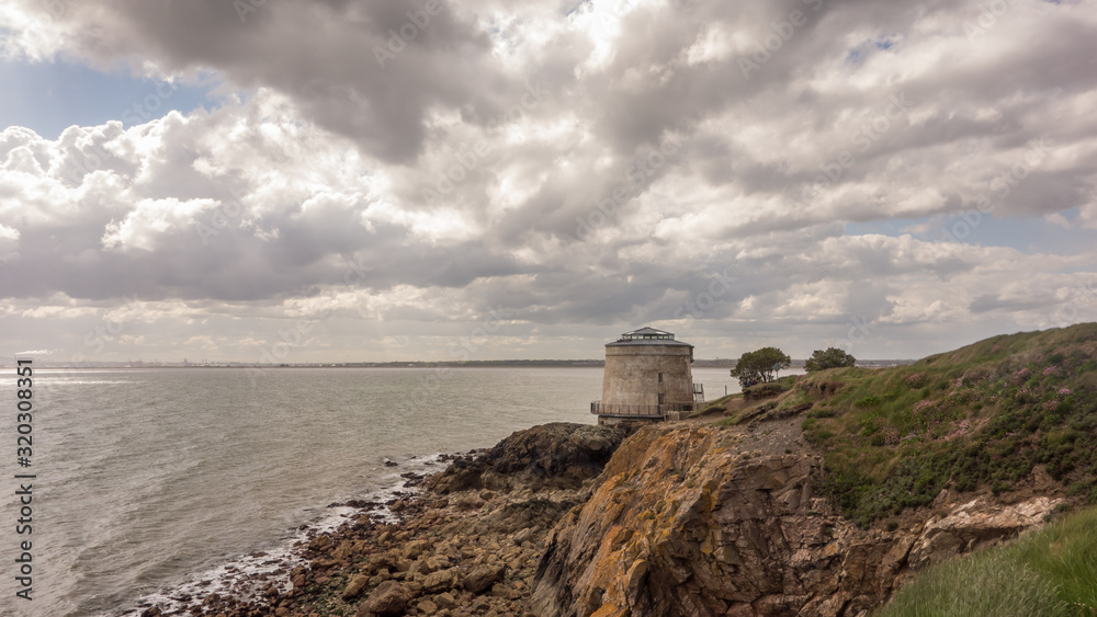 View of a Martello Tower and Dublin Bay at Red Rock, Sutton on Howth Head Peninsula near Dublin, Ireland.