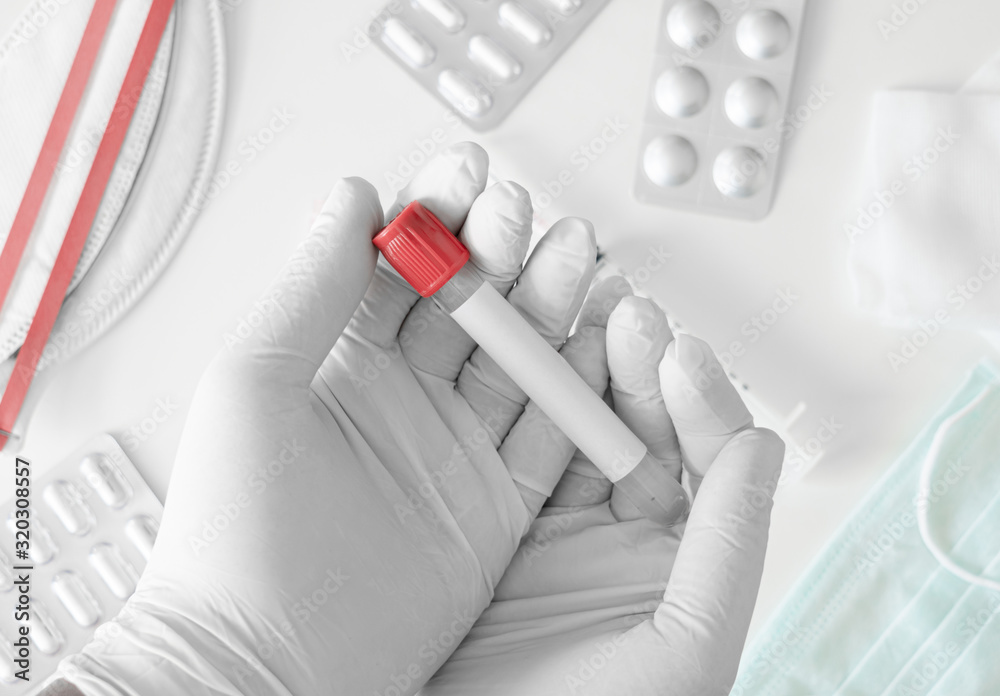 top view of Medical Concept with syringe, Medical Mask, medicine and test tube on white table background top view of Medical Concept with syringe, Medical Mask, medicine and test tube on white table background