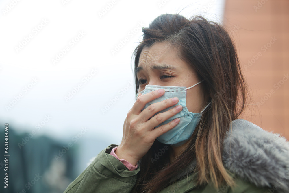 masked girl to protect herself from wuhan virus in public area masked girl to protect herself from wuhan virus in public area