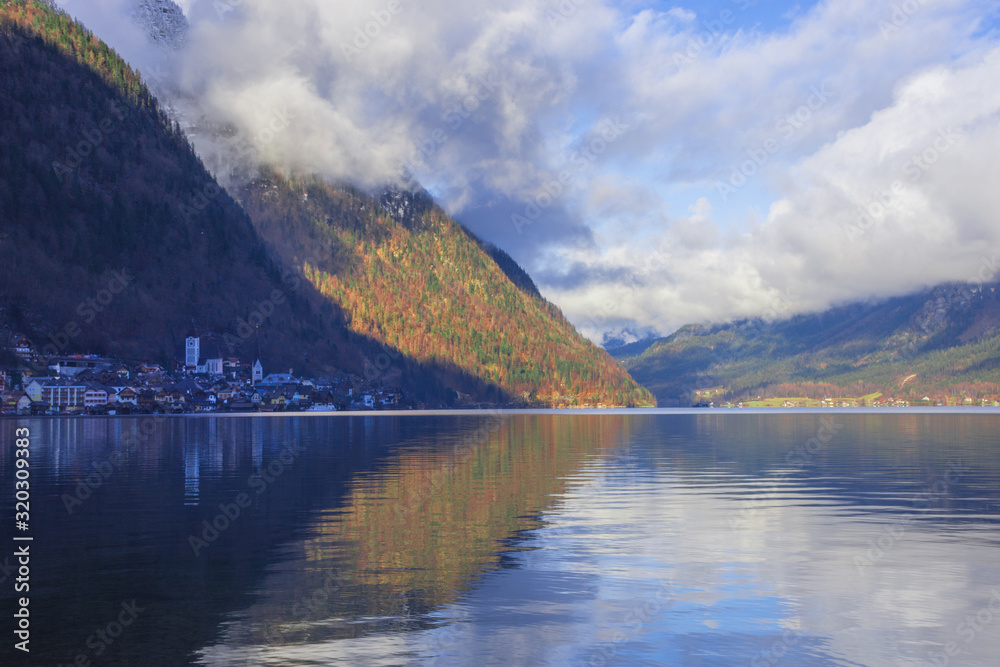 Hallstatt, a charming village on the Hallstattersee lake and a famous tourist attraction, with beautiful mountains surrounding it, in Salzkammergut region, Austria, in winter sunny day.