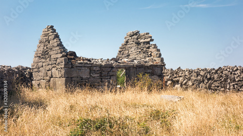 An abandoned, ruined cottage on Inishmaan, one of the Aran Islands off the west coast of Galway, Ireland. photo